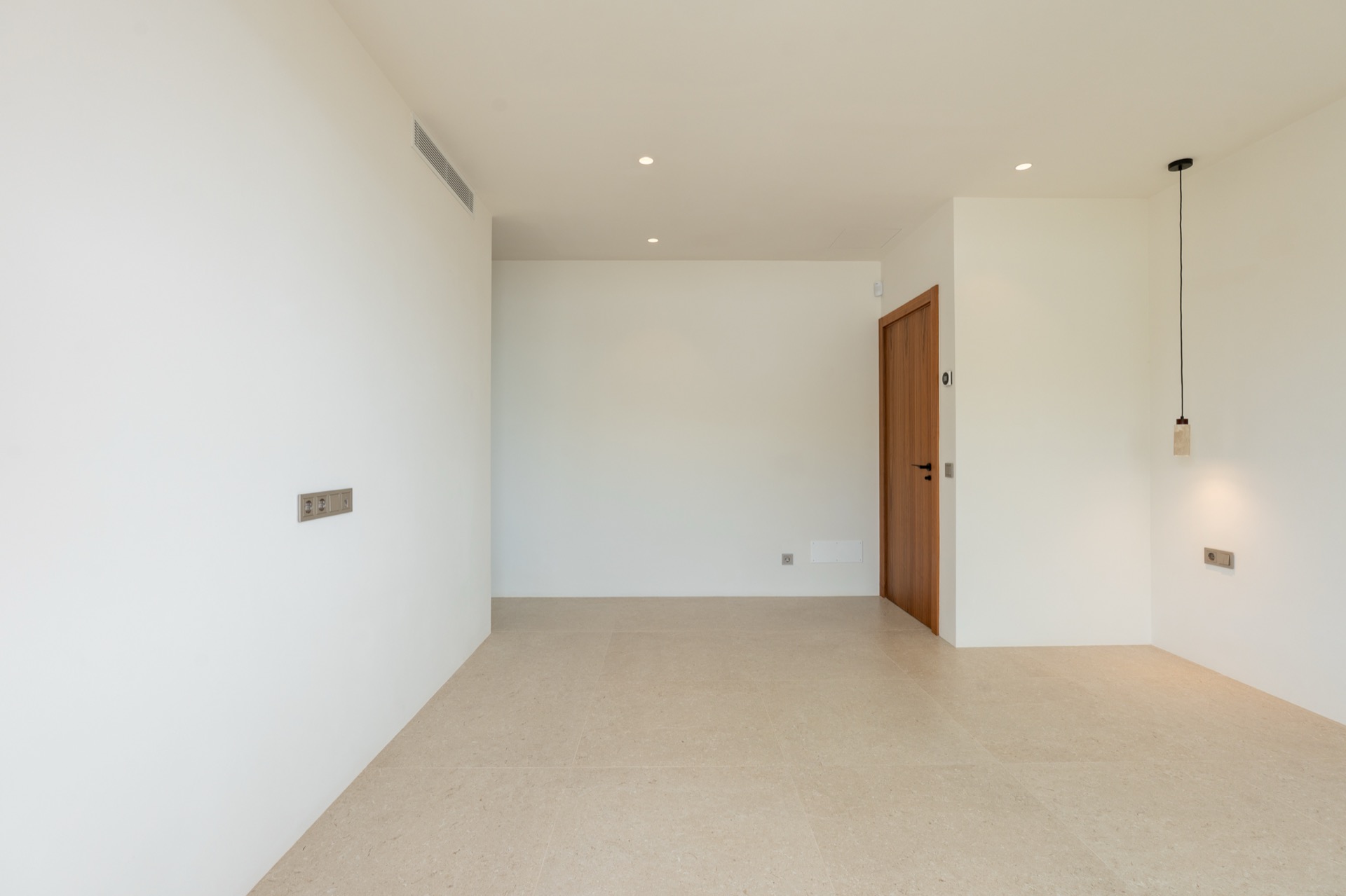 Master bedroom with walnut wardrobe wall