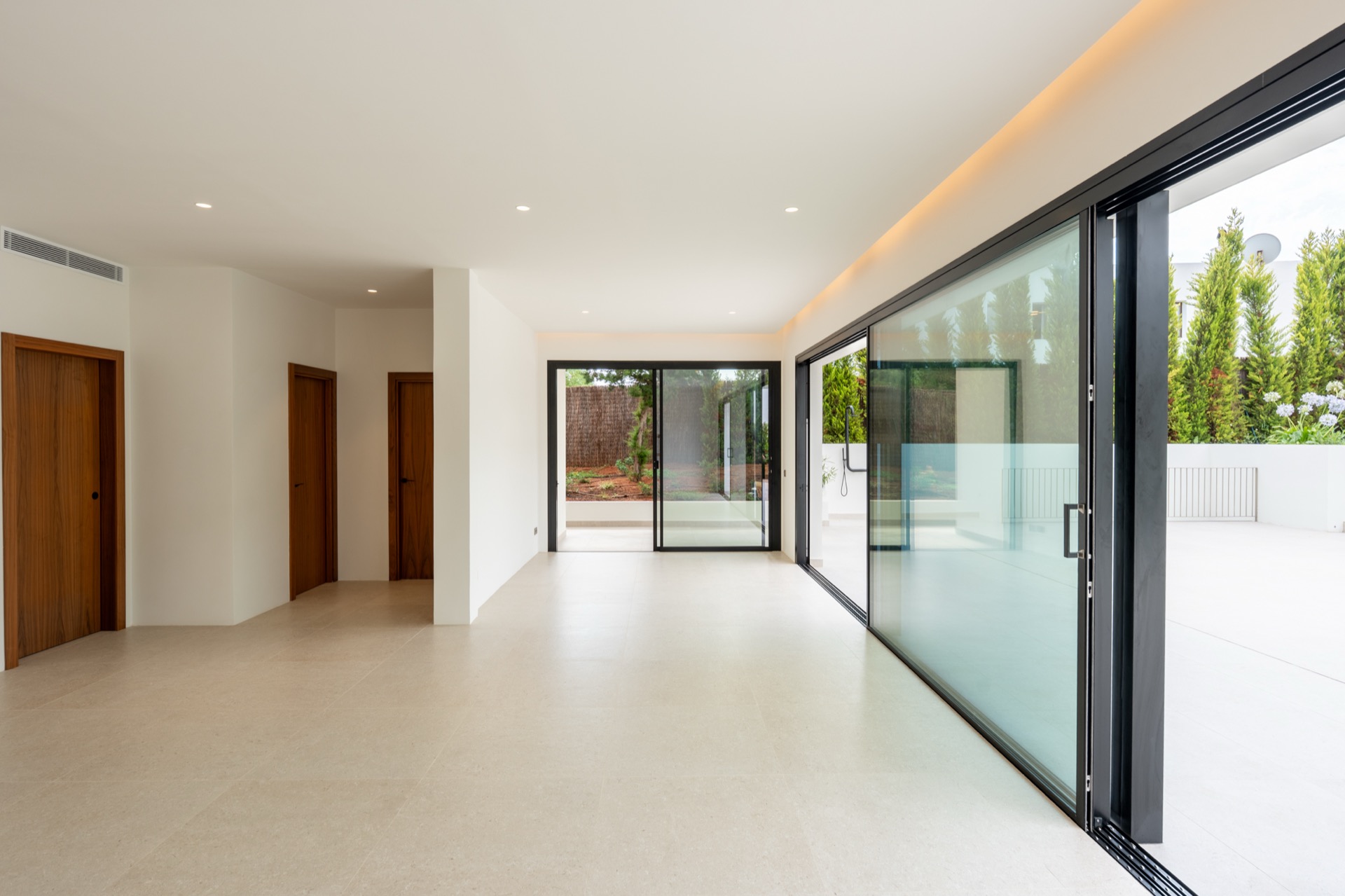 Open-plan living with staircase and pool terrace